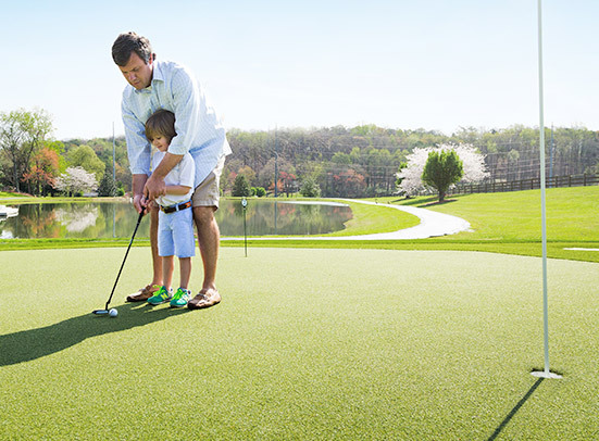 father and son on a putting green