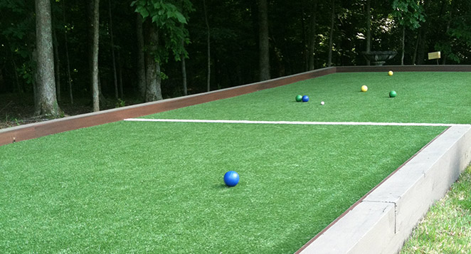 bocce balls resting on a bocce ball court