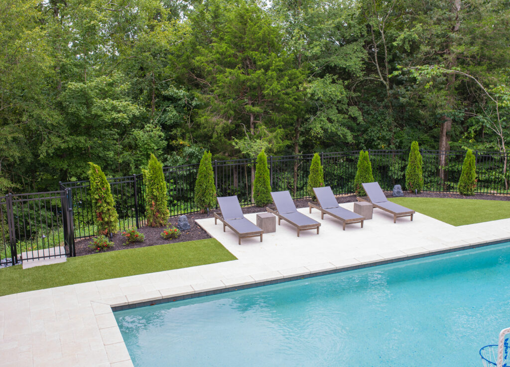 synthetic turf landscaping next to a swimming pool