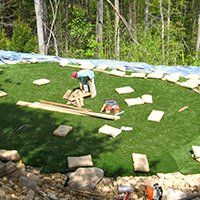 worker laying down turf