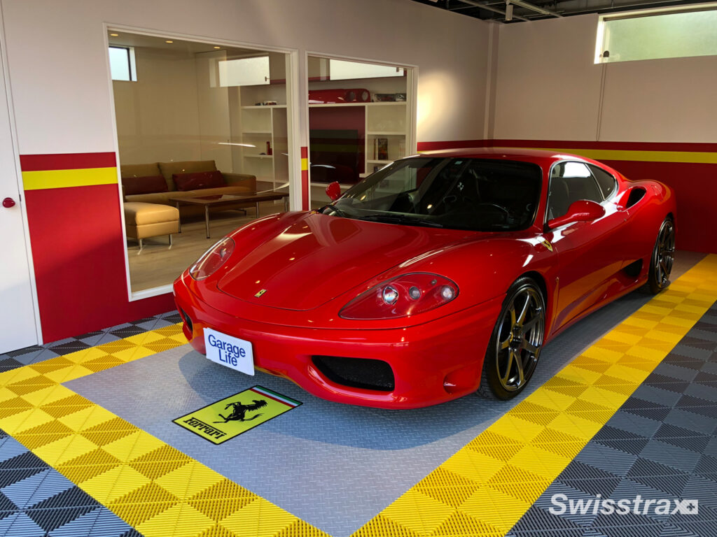 ferrarri parked in a garage with ferrarri themed swisstrax flooring