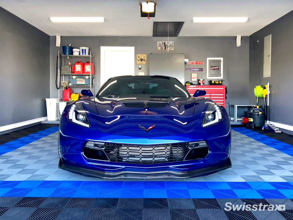 corvette parked in a garage with matching swisstrax flooring