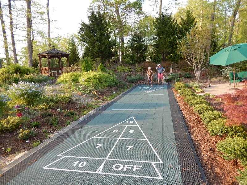 elderly couple playing shuffleboard in the middle of a park
